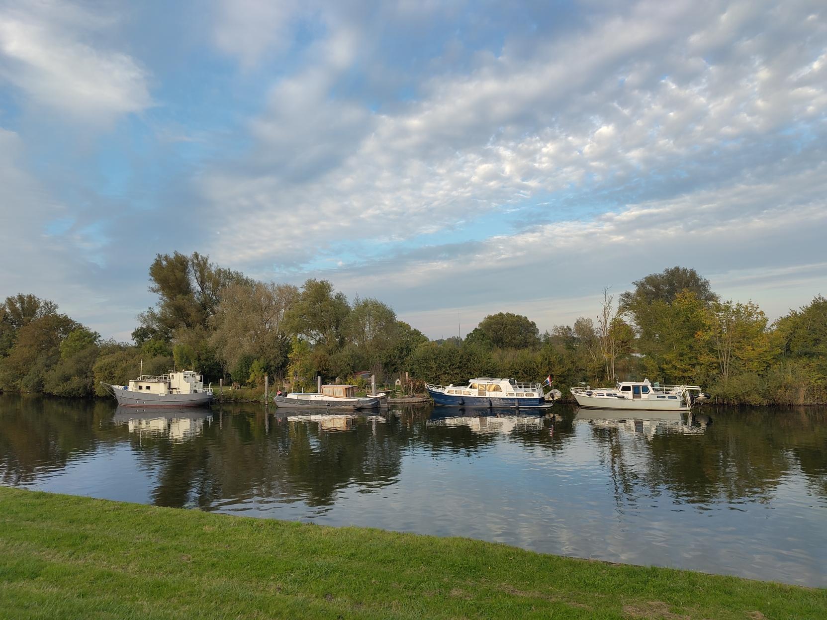 4 boats moored in a river