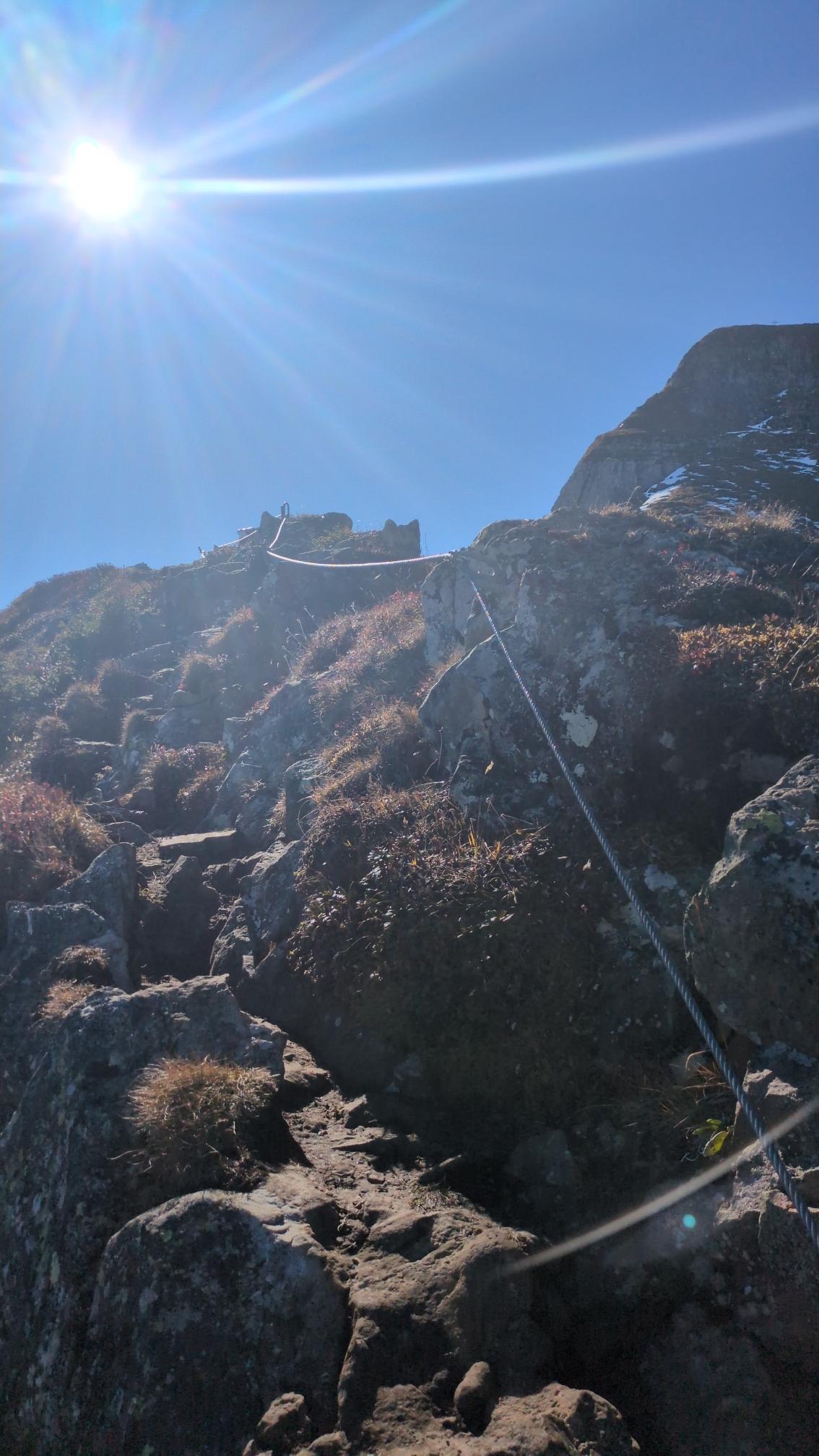 A metal rope for savety on top of a small pre summit.