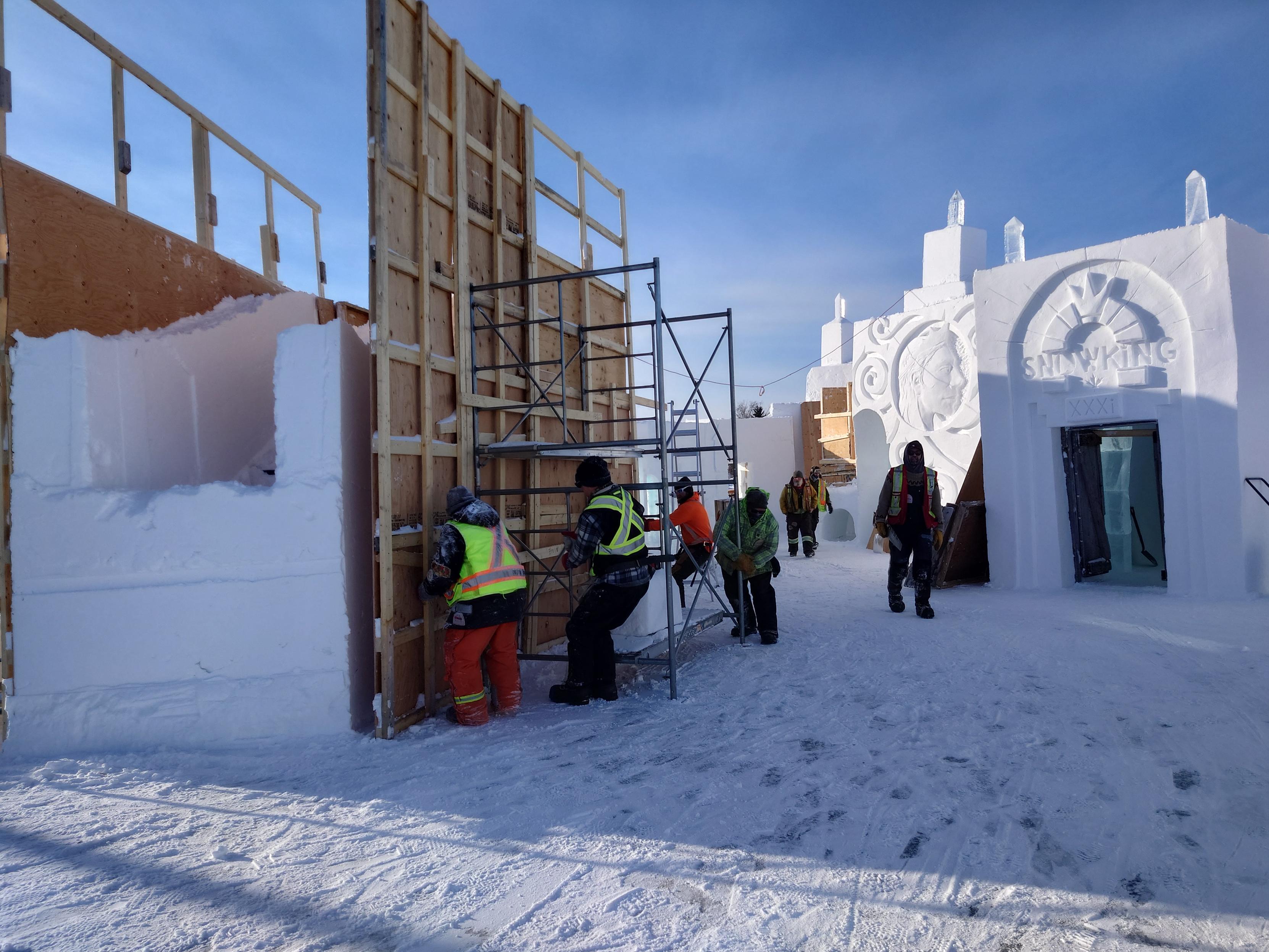 The snow crew move one of the wall forms.